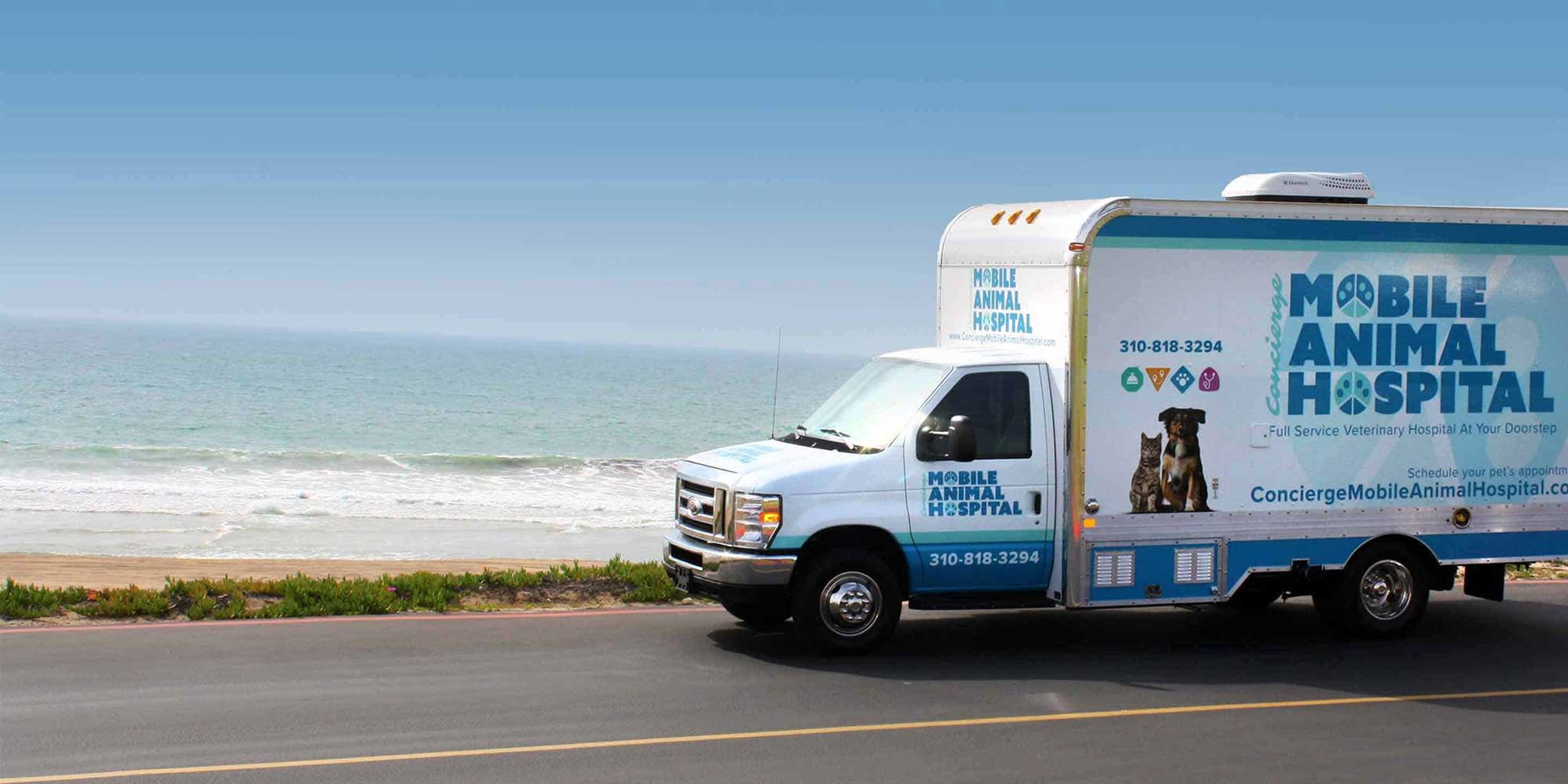 Concierge Mobile Animal Hospital truck driving beside the beach
