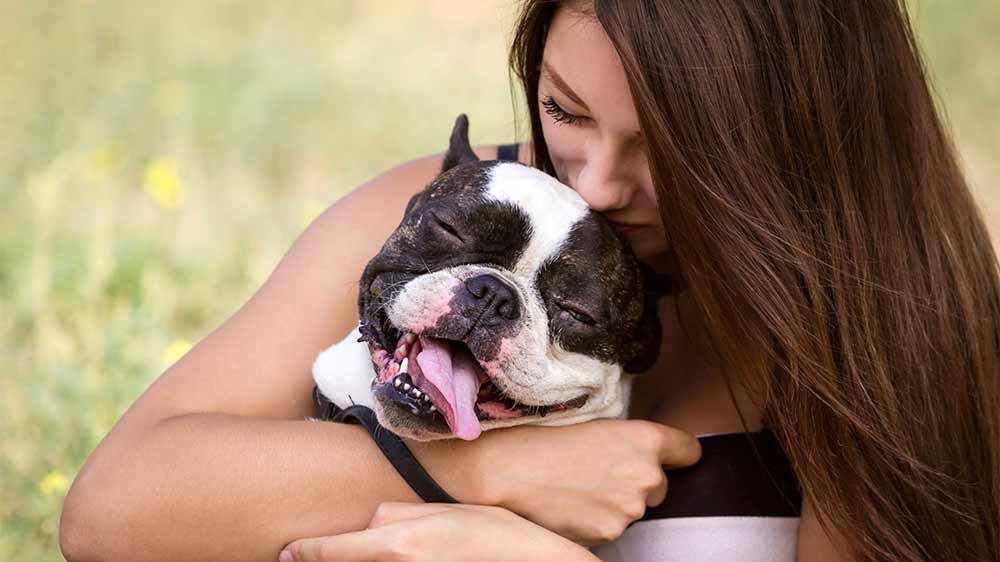 Woman hugging a dog